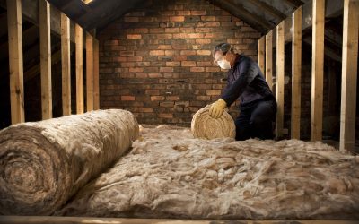 man puts insulation in his loft